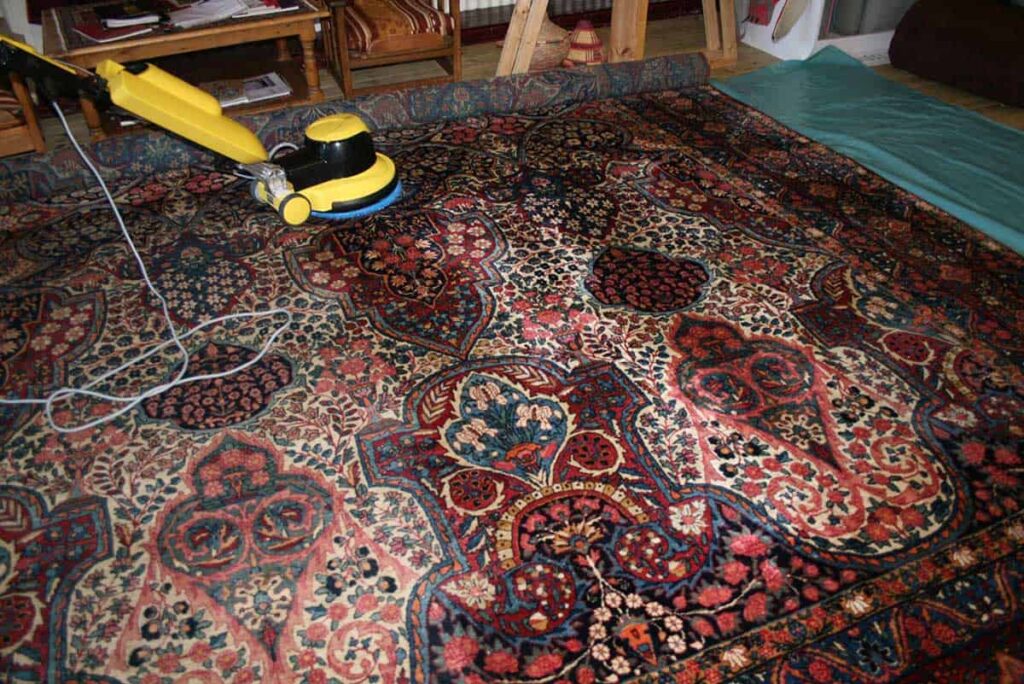 A mechanical buffer running over an Oriental rug for deep cleaning.